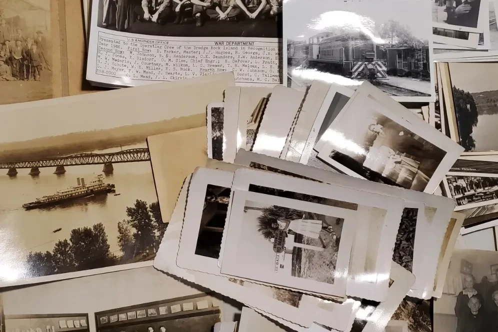 A cardboard box labeled ephemera on a vendor table, filled with postcard-sized paper items and dividers at an antique market